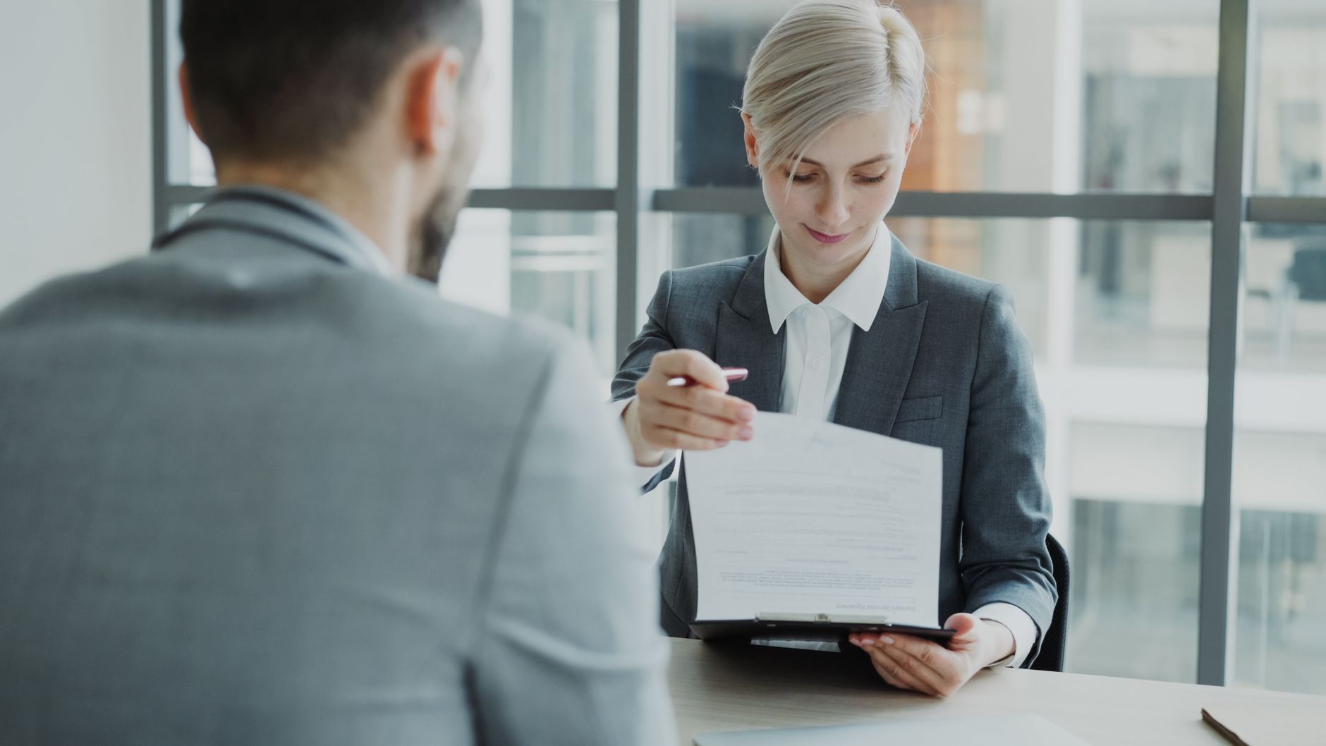 Responsable de RRHH entregando el documento de finiquito a un trabajador